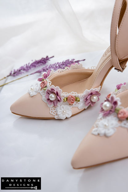 Top view of nude wedding shoes with floral lace and pearl decorations, 9cm heel, displayed with lavender flowers.