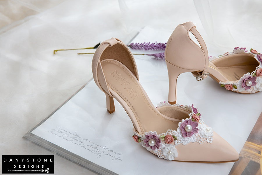 Top view of nude wedding shoes with floral lace and pearl decorations, 9cm heel, displayed with lavender flowers.