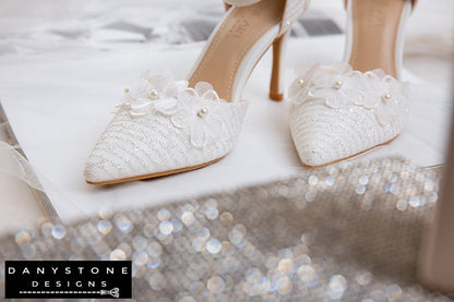 Close-up of floral decorations on white lace bridal shoes, highlighting intricate details and 9cm heel.