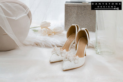 Elegant bridal shoes with chiffon butterfly wings, 9cm heels, and metallic lace fabric, displayed with a glittery box in the background.