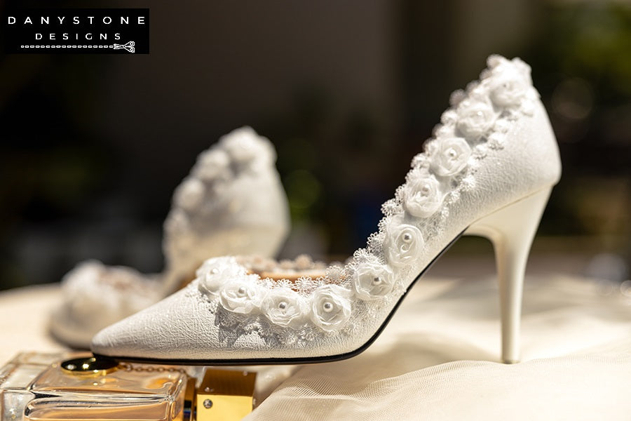 Side view of a white wedding shoe with rose lace trim and 9cm heel, showcasing the intricate lace details.