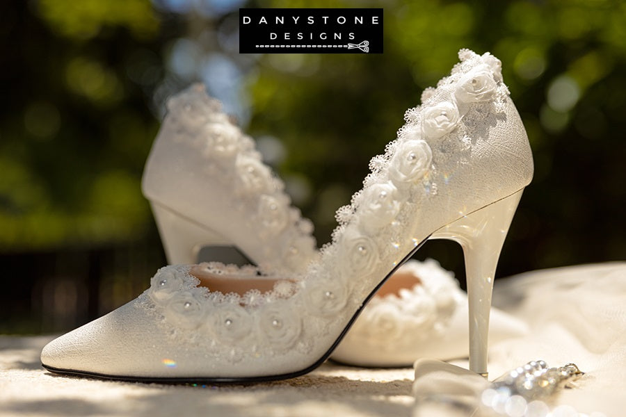 Side view of a white wedding shoe with rose lace trim and 9cm heel, showcasing the intricate lace details.