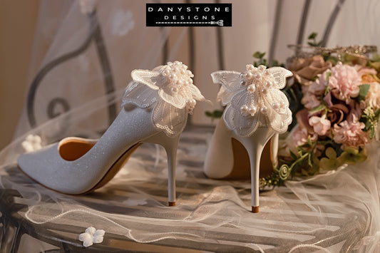 Back view of white wedding shoes with butterfly wings, highlighting the detailed chiffon, beads, and sequins.