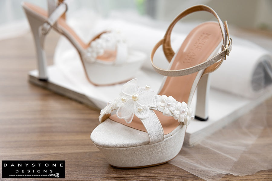 Elegant White Floral Wedding High Heels in an elegant setup with tulle background.