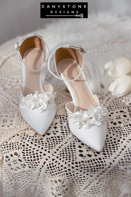 Side view of Elegant White Floral Wedding Shoes with an ankle strap, pearl decorations, and a 7 cm heel.