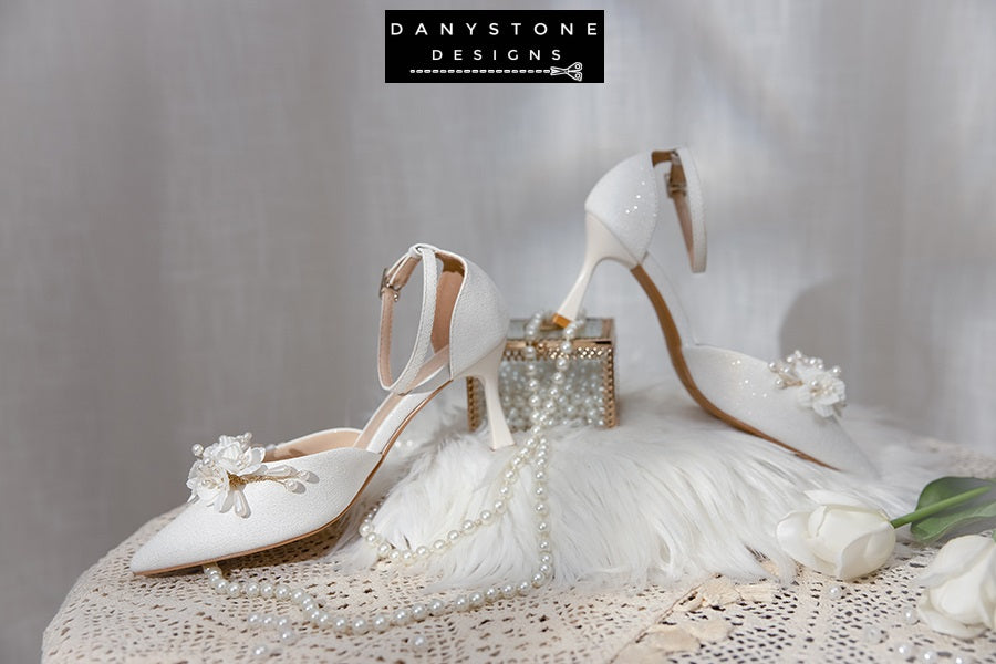 Close-up of the floral detail on Elegant White Floral Wedding Shoes with lightly shimmering metallic leather.