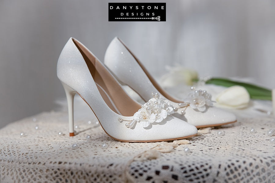 Close-up of the floral and pearl detail on Elegant White Metallic Leather Wedding Heels.