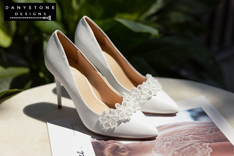 "Close-up of white crystal flower petals on 10cm wedding shoes with gentle shimmer"