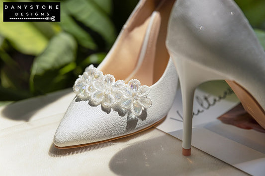 "Close-up view of elegant 10cm crystal beaded wedding shoes with white crystal flower petals"