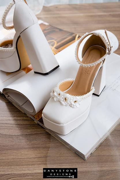 Pair of elegant white wedding heels with double square toe and floral decorations, featuring a 13cm heel.