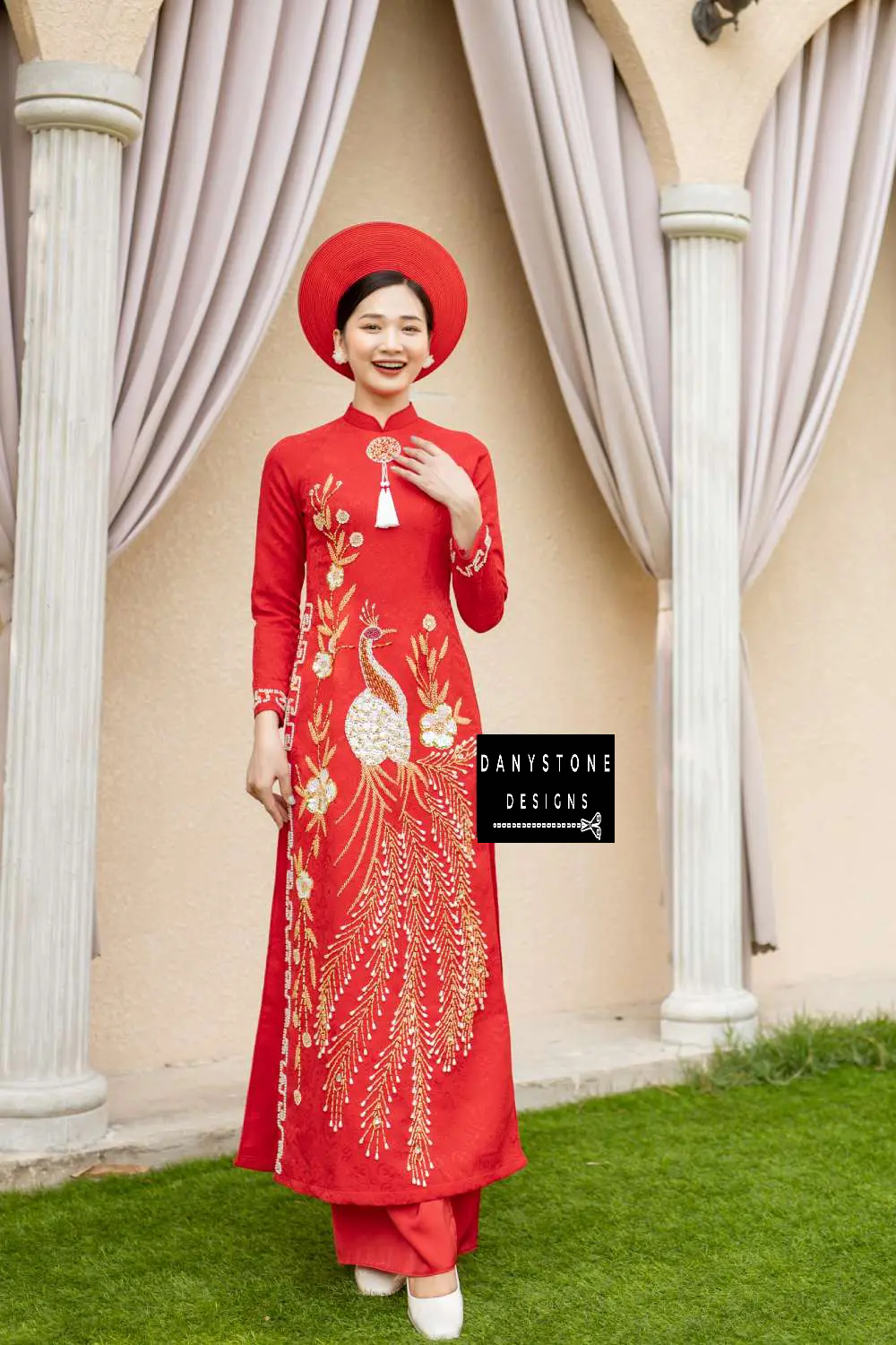 Side view of a red brocade bridal Áo Dài with phoenix embroidery and beaded details.