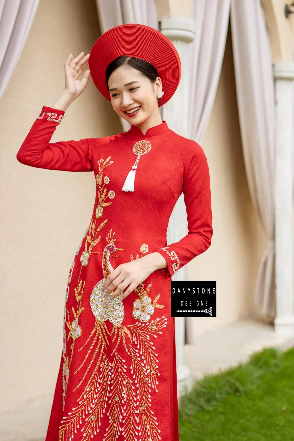 Woman in a royal red brocade Áo Dài, featuring intricate phoenix design and luxurious fabric.