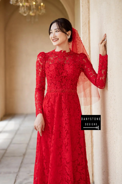 Side profile of a bride wearing the Red Lace Bridal Ao Dai, illustrating the dress's exquisite lace fabric and modern design.