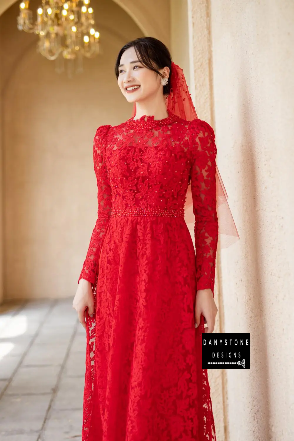 Detailed shot of the Red Lace Bridal Ao Dai's upper body, featuring pearl decorations that add brilliance and elegance.