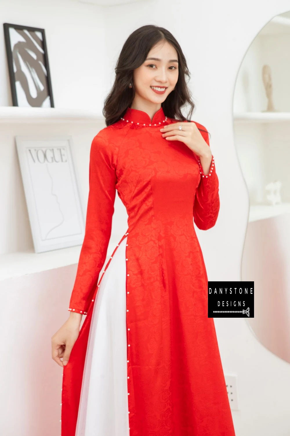 Side view of a bride in a Red Brocade Bridal Ao Dai with a 4-panel jade border, highlighting the elegant design and soft brocade fabric.