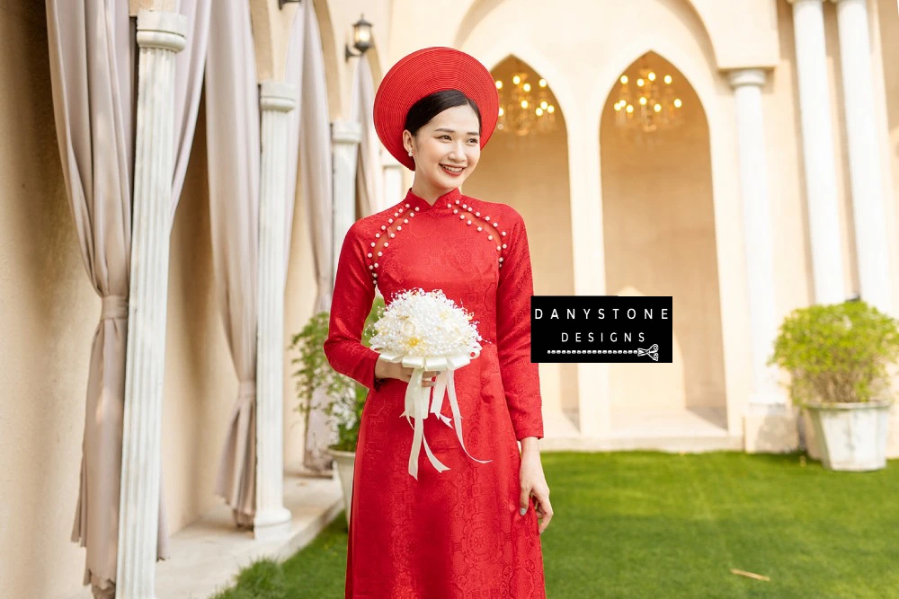 Side view of the Pearl-Trimmed Brocade Bridal Ao Dai, capturing the delicate combination of pearl edges and see-through fabric.