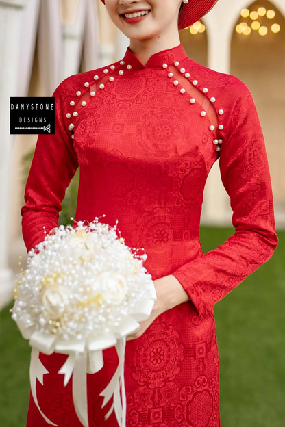 Close-up of a Pearl-Trimmed Brocade Bridal Ao Dai, showcasing the intricate pearl edges and happy motifs on the fabric.