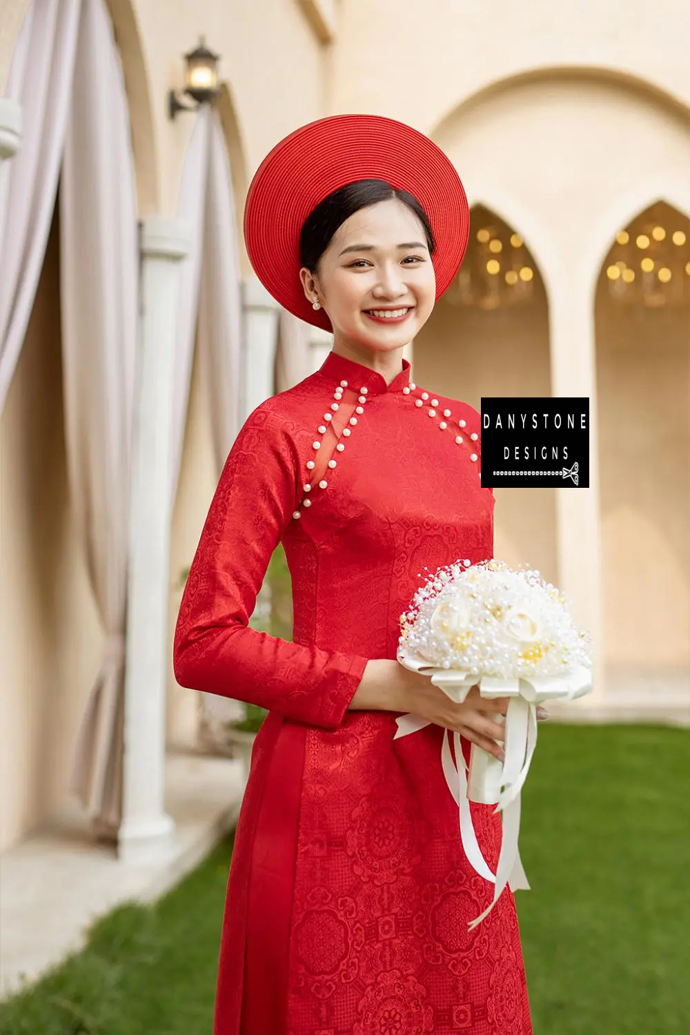 Front view of a bride wearing the Pearl-Trimmed Brocade Bridal Ao Dai, highlighting the luxurious brocade fabric and traditional design.