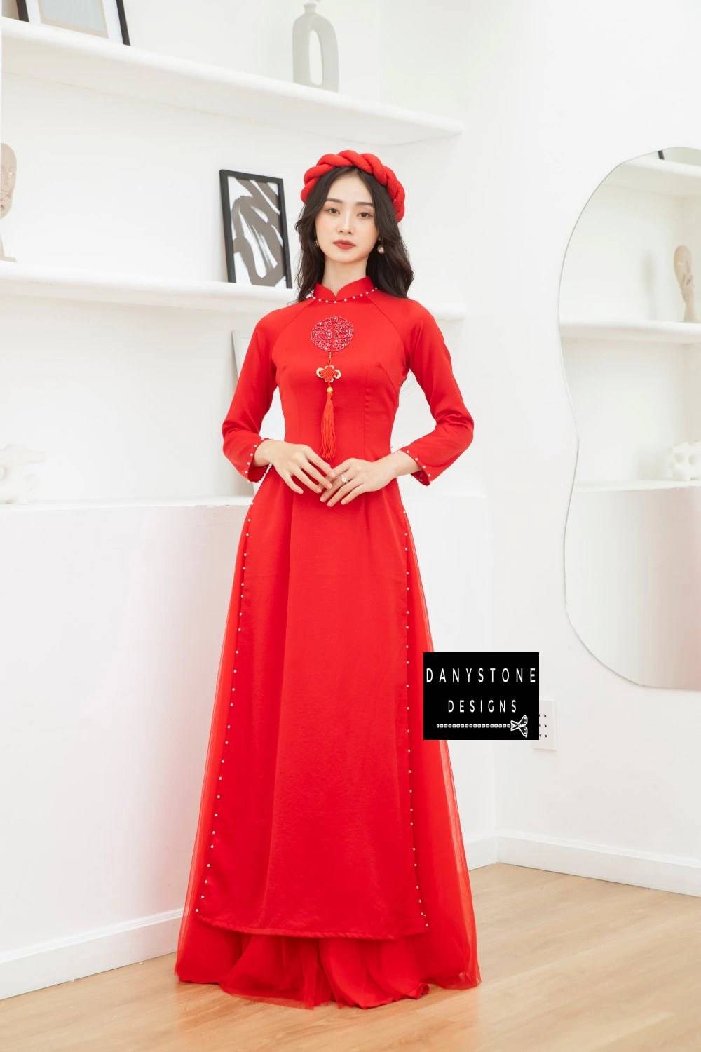 Side view of the Bright Red Silk Wedding Ao Dai, capturing the delicate pearl accents along the hem and sleeves.