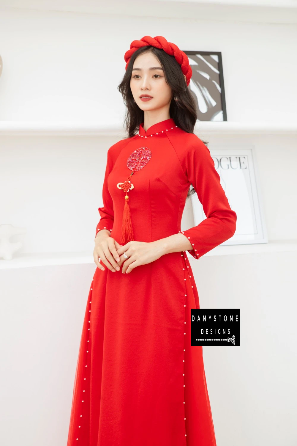 Bride adjusting the collar of the Bright Red Silk Wedding Ao Dai, illustrating the graceful and gentle beauty of the dress.