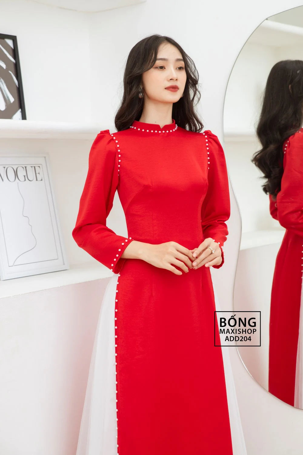 Bride wearing an Elegant Red Silk Bridal Ao Dai with pearl trim, showcasing traditional elegance and modern charm.