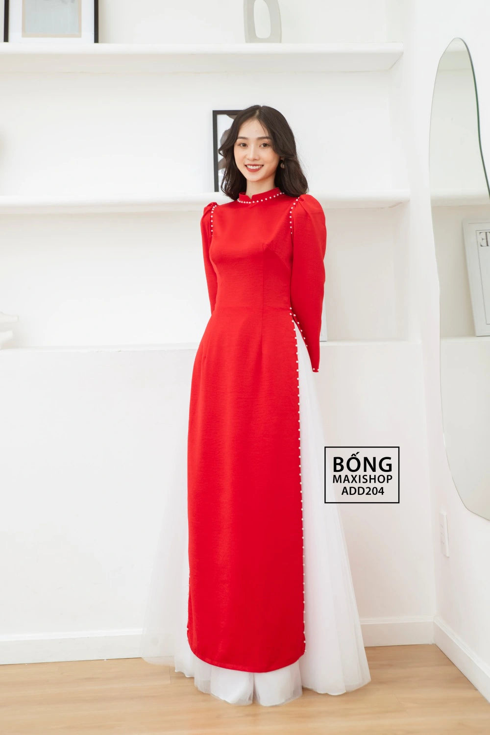 Full-length view of the Red Silk Bridal Ao Dai, capturing the graceful design and fluttery sleeves.