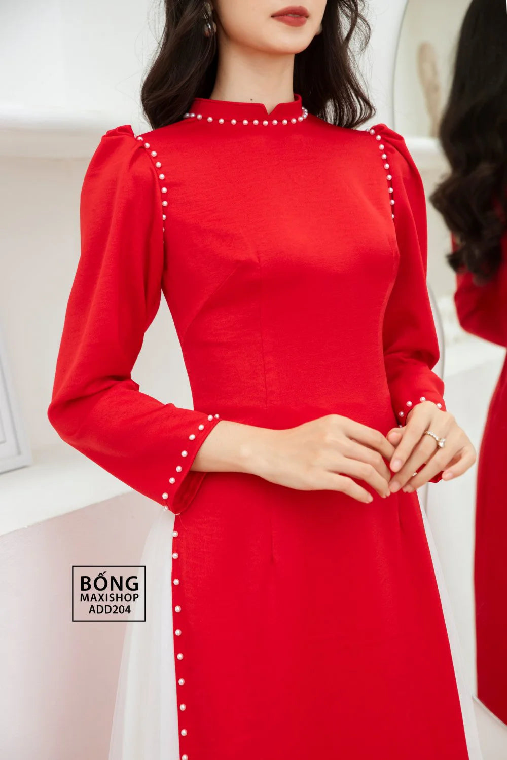 Close-up of the pearl trim on the Elegant Red Silk Bridal Ao Dai, highlighting the intricate details and luxurious silk fabric.