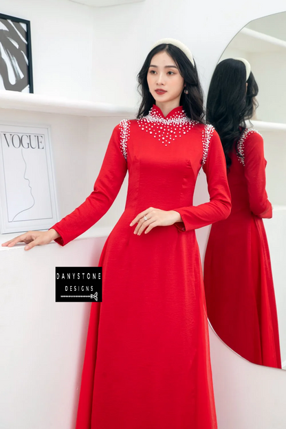 Bride posing in the Red Silk Bridal Ao Dai, illustrating the traditional beauty and luxurious appeal of the dress.