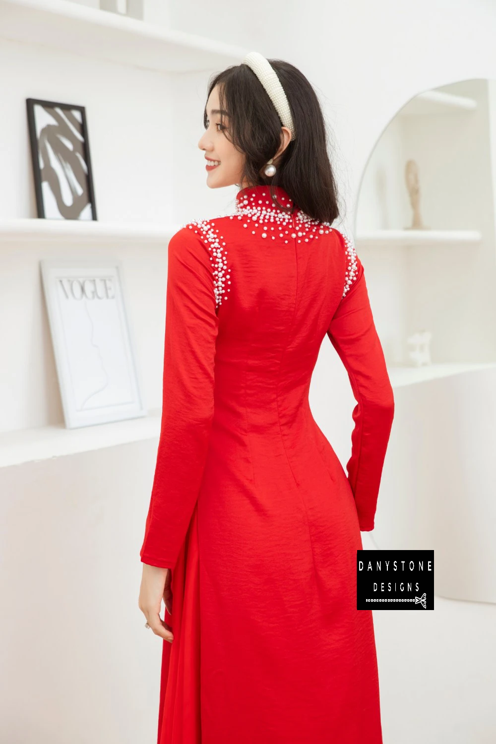 Close-up of the pearl decorations on the Red Silk Bridal Ao Dai, showcasing its elegant and sophisticated design.