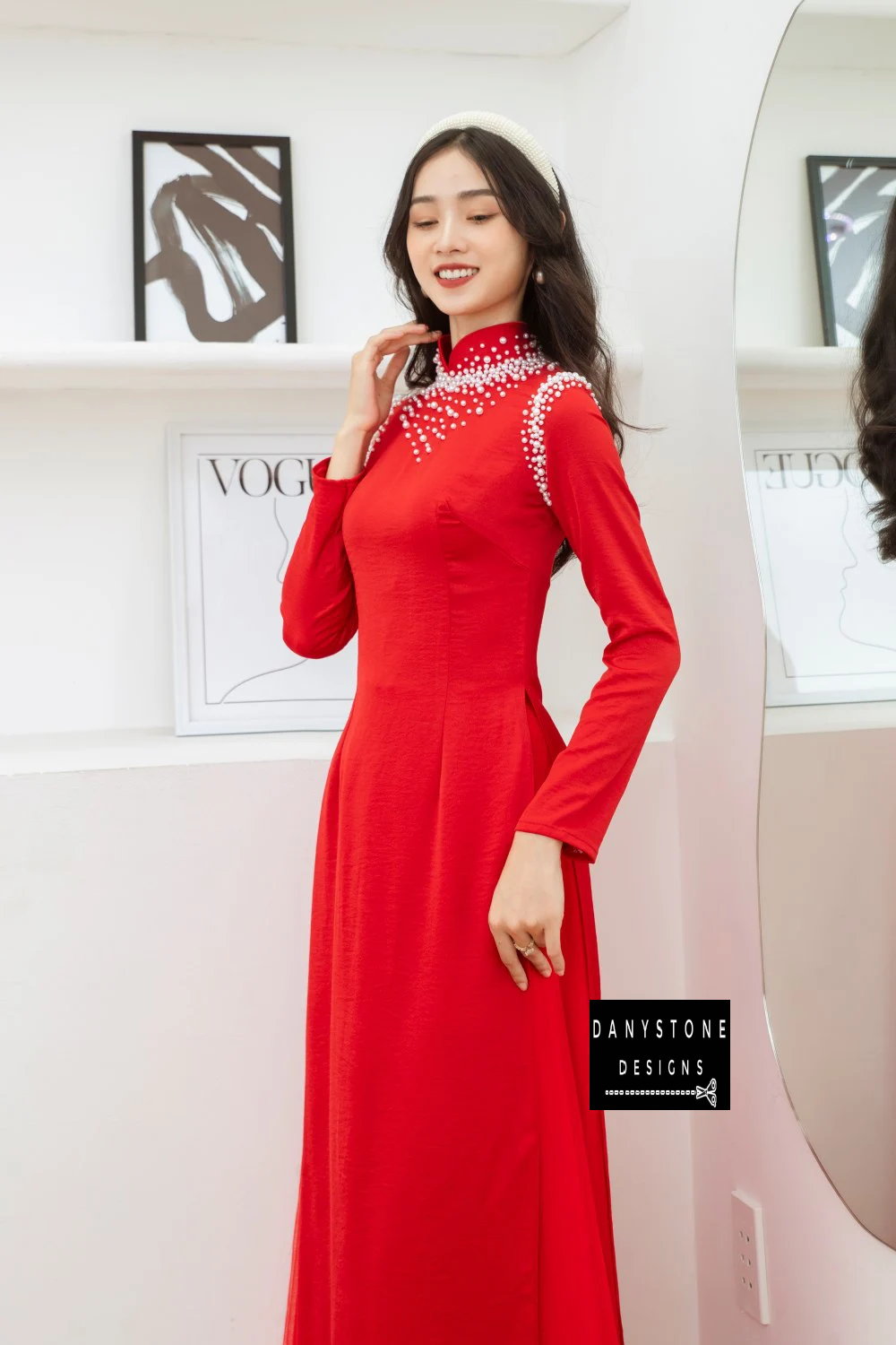 Full-length view of a bride wearing the Red Silk Bridal Ao Dai with pearl details, highlighting the elegant design and graceful flow.