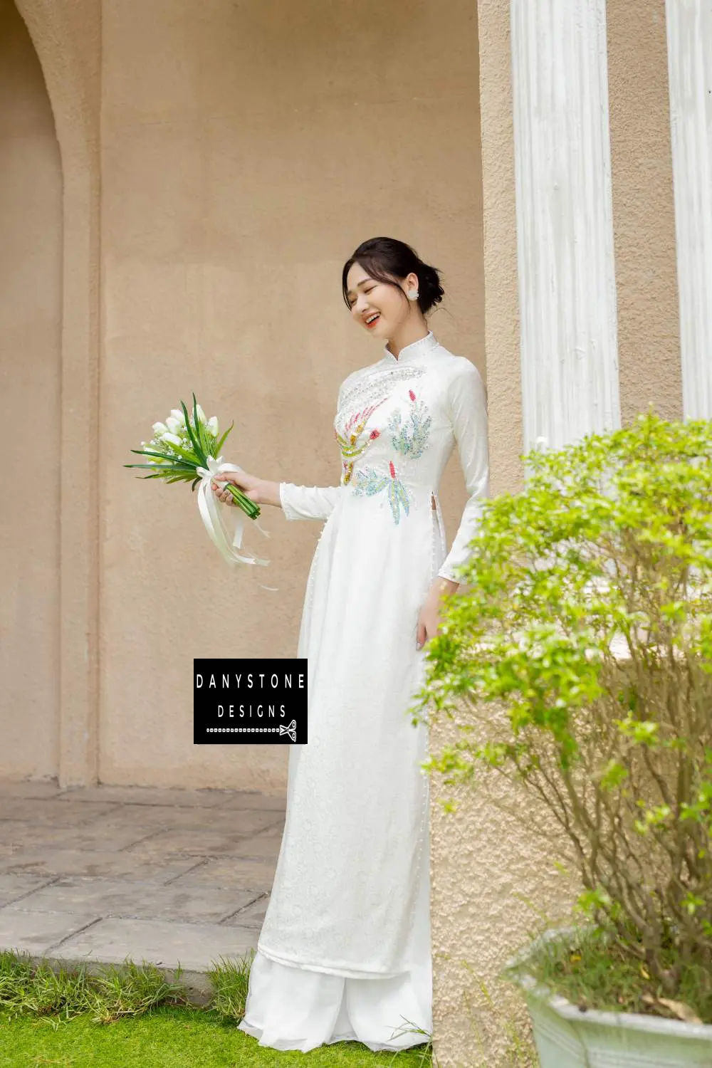 Full-length view of the White Brocade Bridal Ao Dai, capturing the graceful flow and luxurious design.