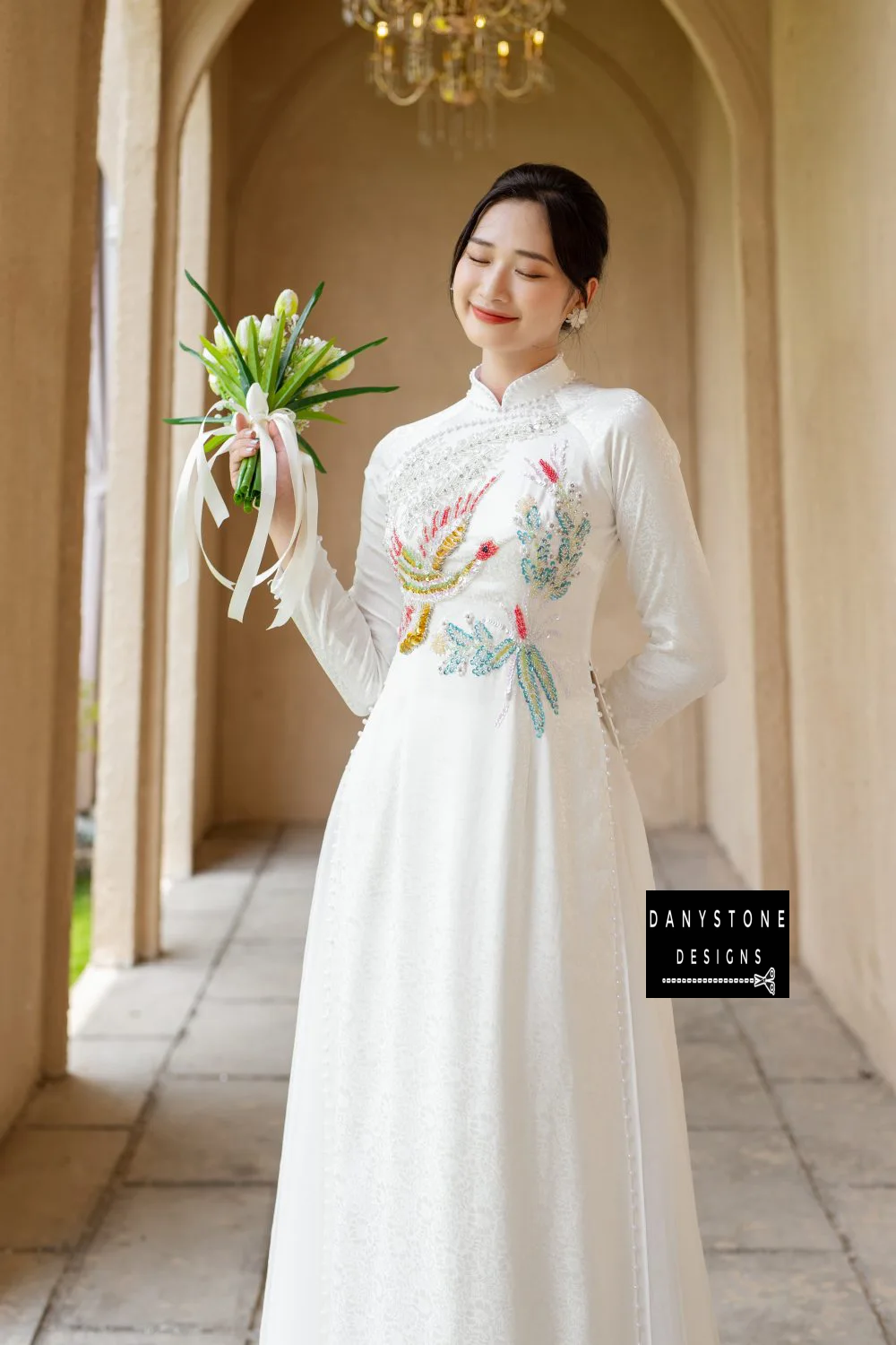 Side view of the White Brocade Bridal Ao Dai with phoenix collar and pearl edges, emphasizing the soft brocade fabric and elegant embellishments.