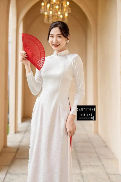 Full-length view of a bride wearing the Elegant White Brocade Ao Dai with beaded collar, highlighting the elegant design and graceful flow.