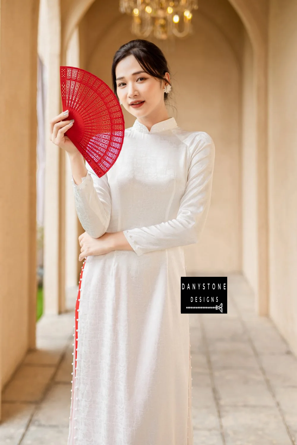 Side view of the White Brocade Ao Dai, capturing the soft fabric and delicate beaded embellishments.