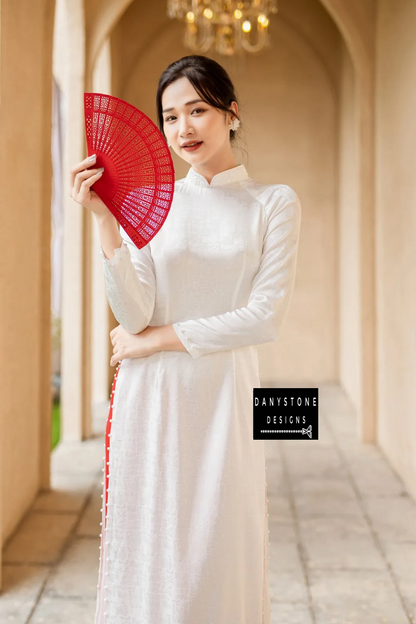 Side view of the White Brocade Ao Dai, capturing the soft fabric and delicate beaded embellishments.