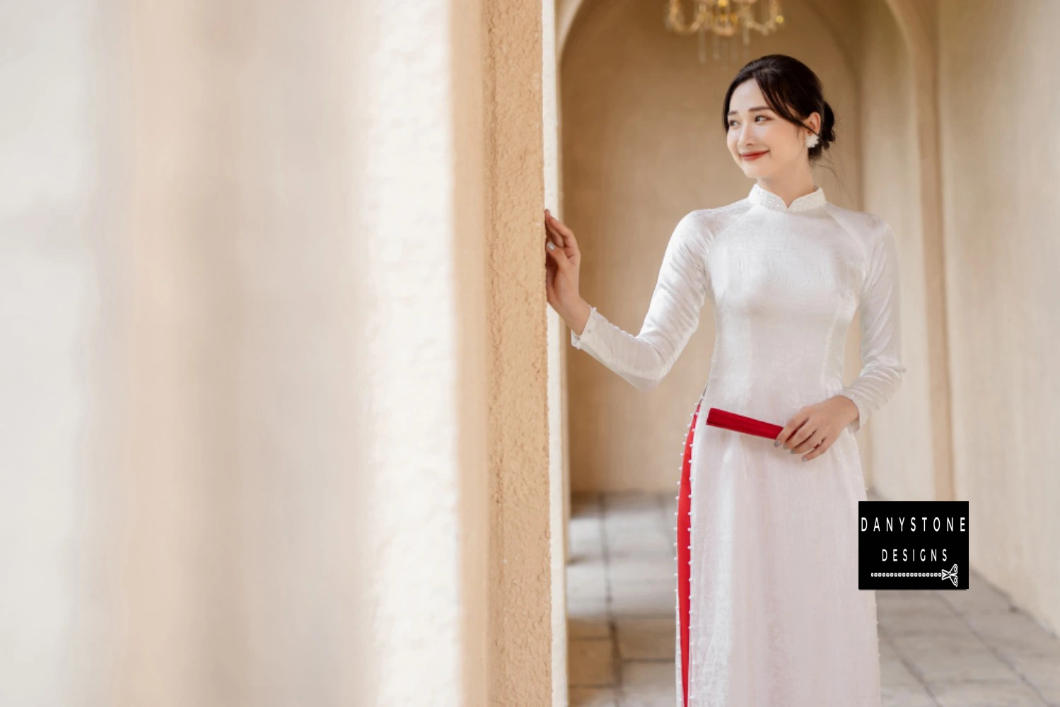 Detailed shot of the beaded collar and hem on the White Brocade Ao Dai, emphasizing its intricate craftsmanship.