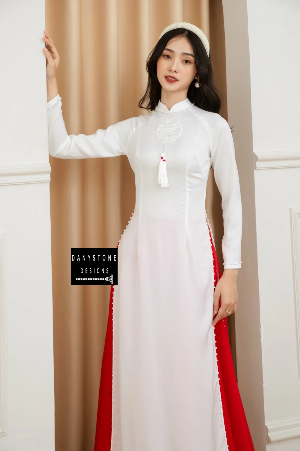 Detail shot of the pearl-studded hem on the Elegant White Silk Wedding Ao Dai, illustrating the meticulous craftsmanship.