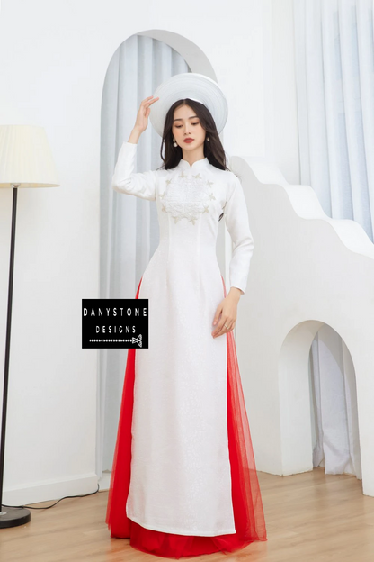 Full-length view of a bride wearing the Graceful White Brocade Beaded Bridal Ao Dai, standing elegantly with a soft background.