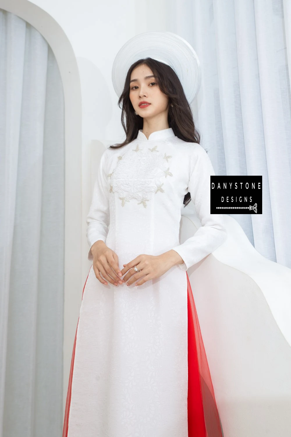 Front view of the Graceful White Brocade Beaded Bridal Ao Dai, emphasizing the clean lines and elegant design with red accents.