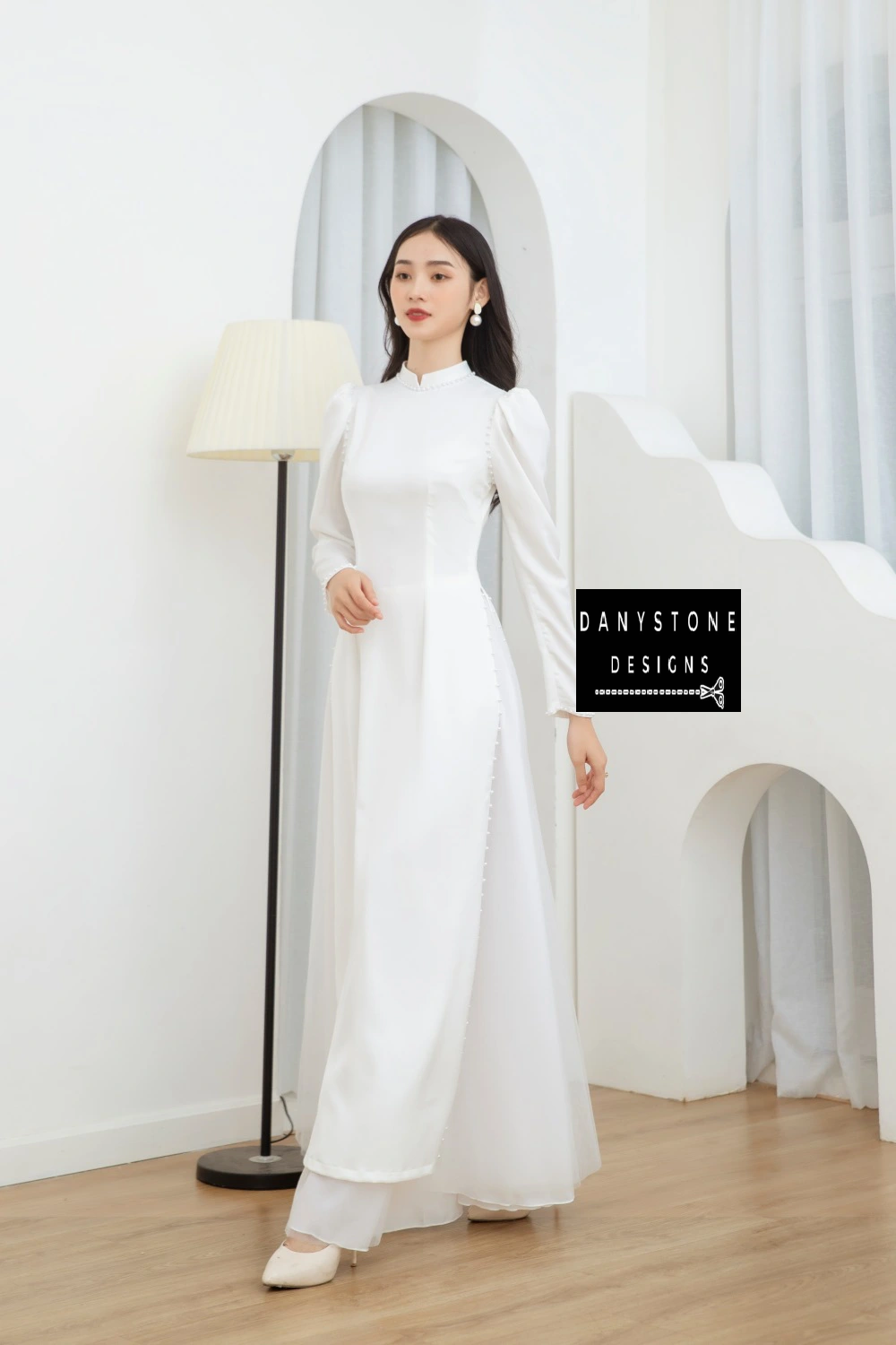 Front view of the Graceful White Silk Bridal Ao Dai, emphasizing the clean lines and luxurious pearl trim.