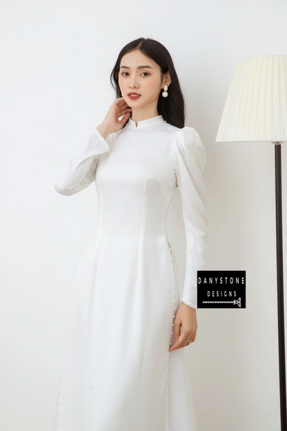 Bride posing gracefully in the Graceful White Silk Bridal Ao Dai, exuding pure and elegant beauty on her special day.