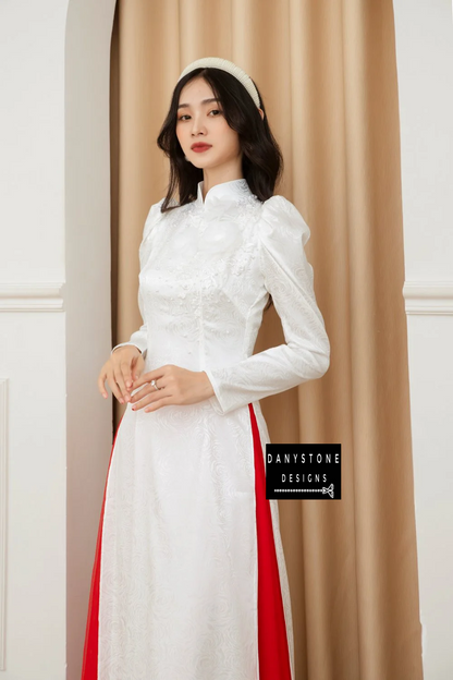 Front view of the Sophisticated White Brocade Ao Dai, displaying the luxurious pearl trim and floral embellishments.