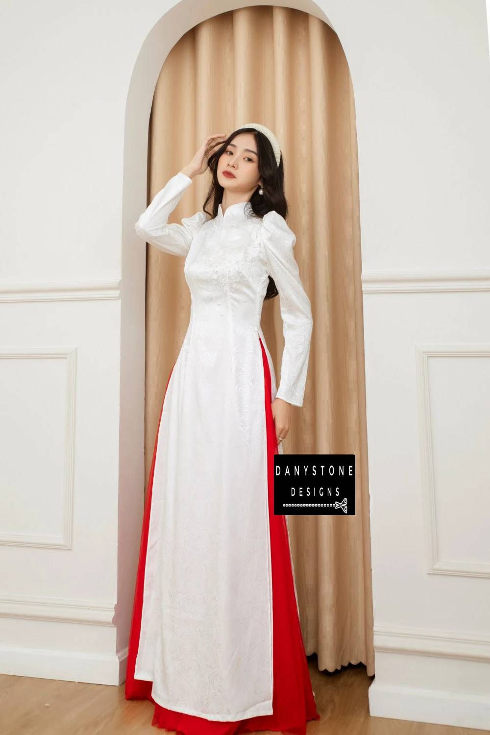 Bride posing gracefully in the Sophisticated White Brocade Ao Dai, exuding a clear and pure beauty with every step.