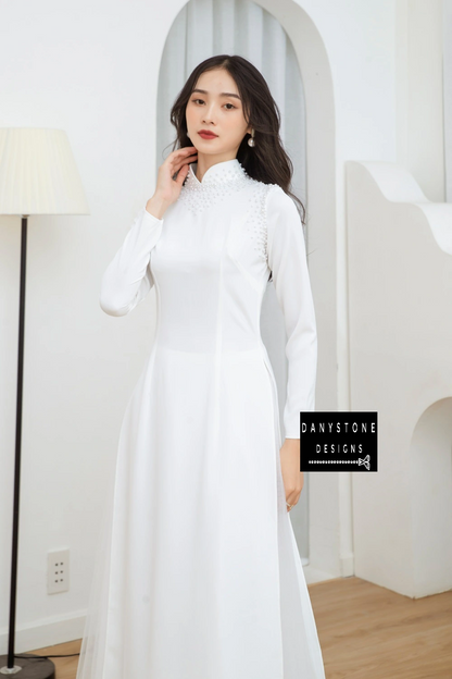 Full-length view of a bride wearing the Pearl White Silk Bridal Ao Dai, showcasing the pure white fabric and elegant design.