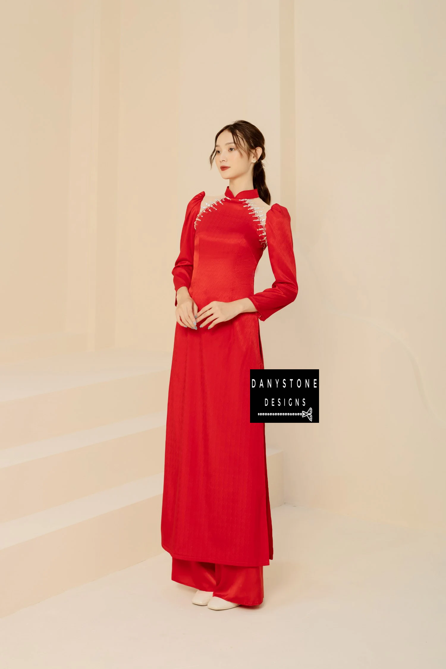 Red silk bridal Áo Dài with novel chest design and elegant shrug sleeves, worn by a bride.