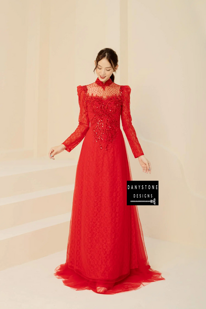 Red lace Áo Dài with sparkly beaded floral patterns, worn by a bride.