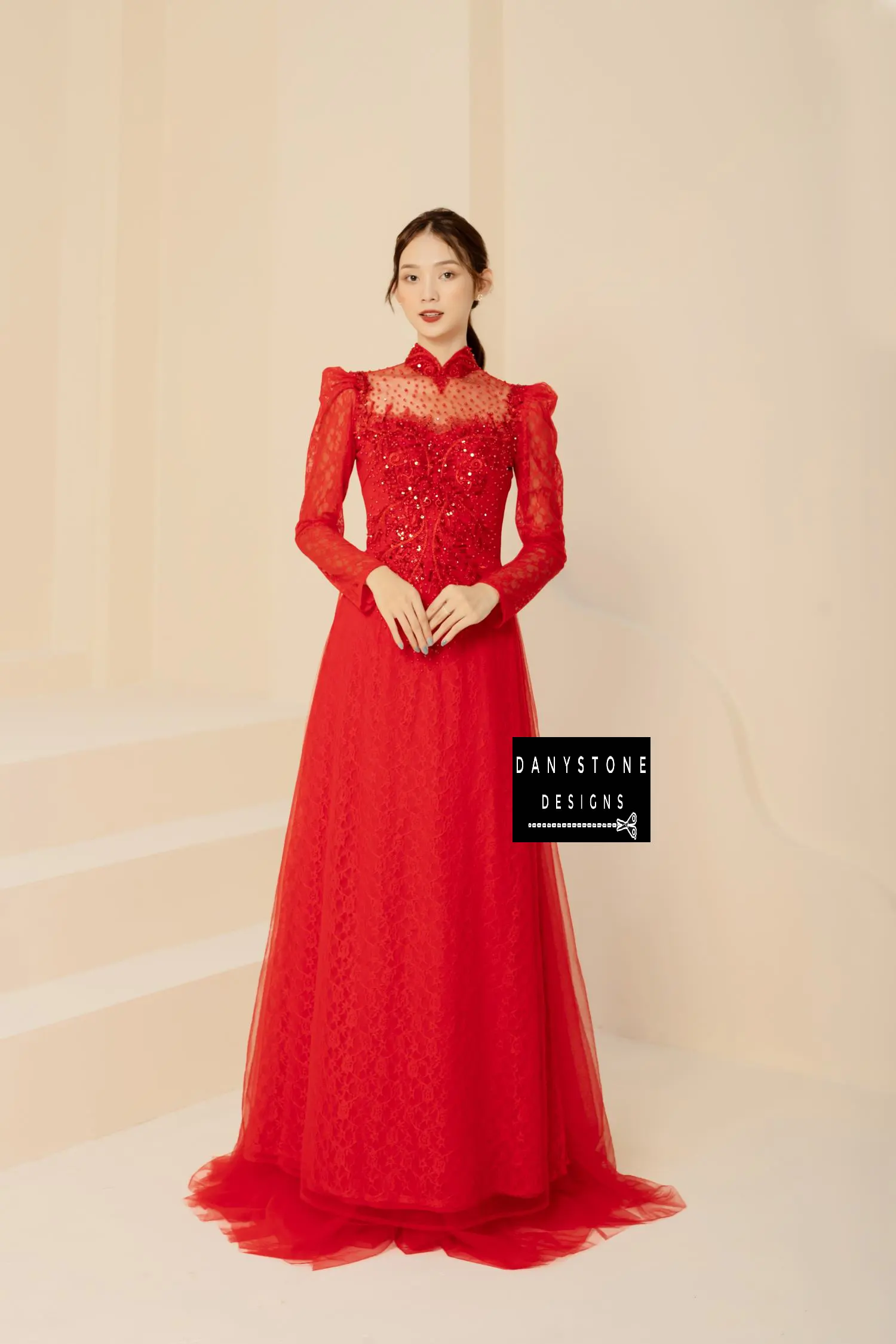 Red lace Áo Dài with sparkly beaded floral patterns, worn by a bride.