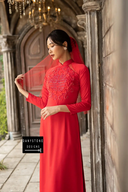 Side view of a red silk bridal Áo Dài with delicate beaded flowers and circles.