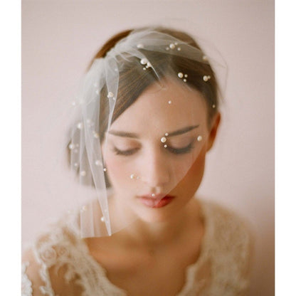 Bride wearing a 40cm short beaded veil adorned with scattered pearls, styled with a lace wedding gown.