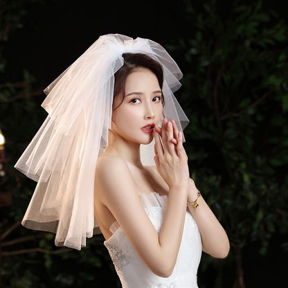 Bride wearing a 3-layer short bridal veil, featuring soft tulle layers of 34cm, 45cm, and 65cm, paired with a strapless wedding gown.